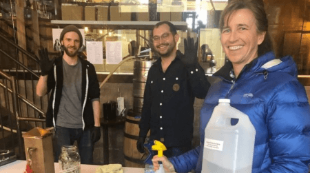 Staff at Vikre Distillery pose in their facility