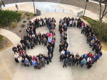 An overhead picture of IC Systems employees standing in the shape of an 80